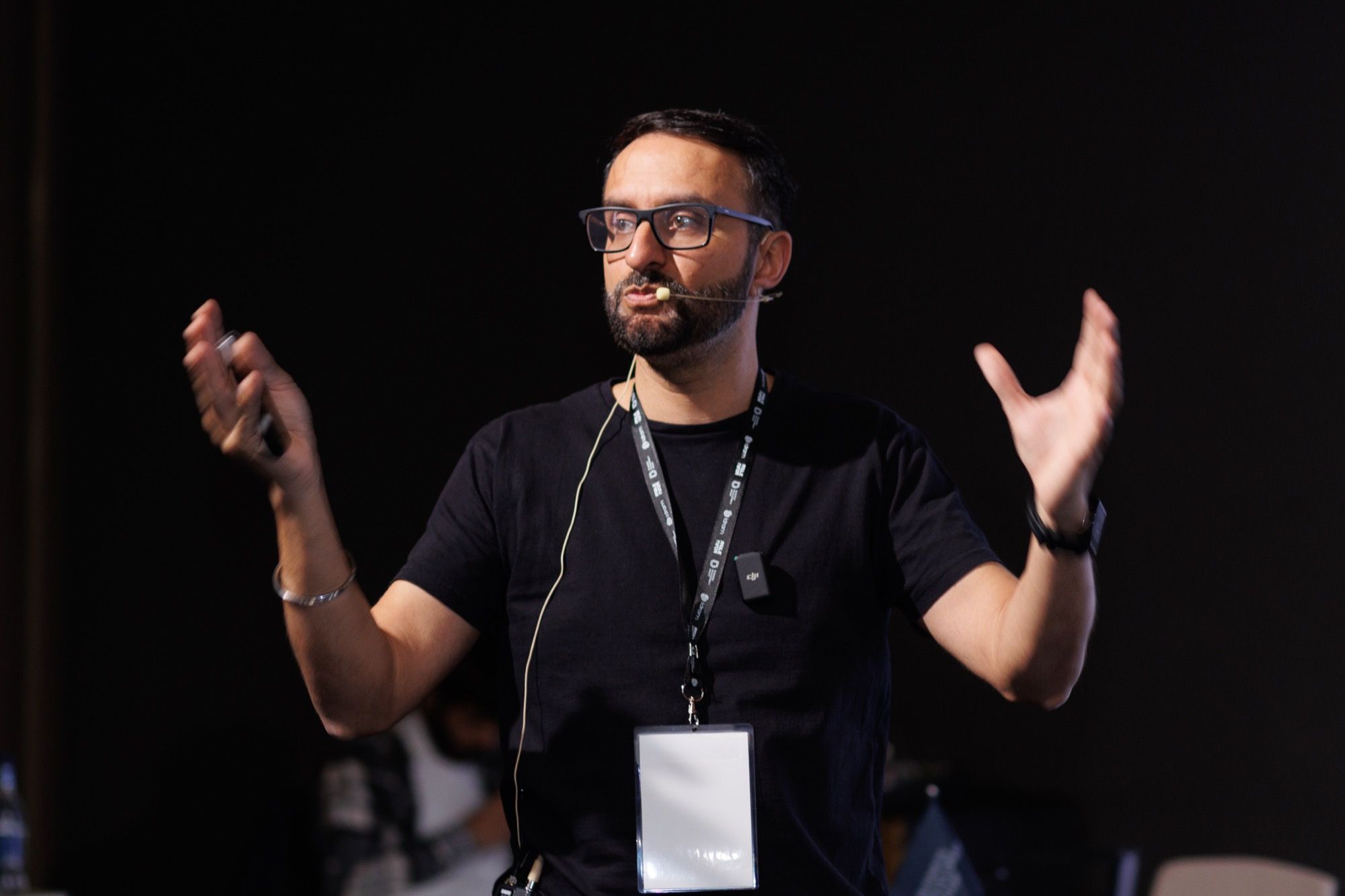 Paddy speaking on stage with a headset microphone