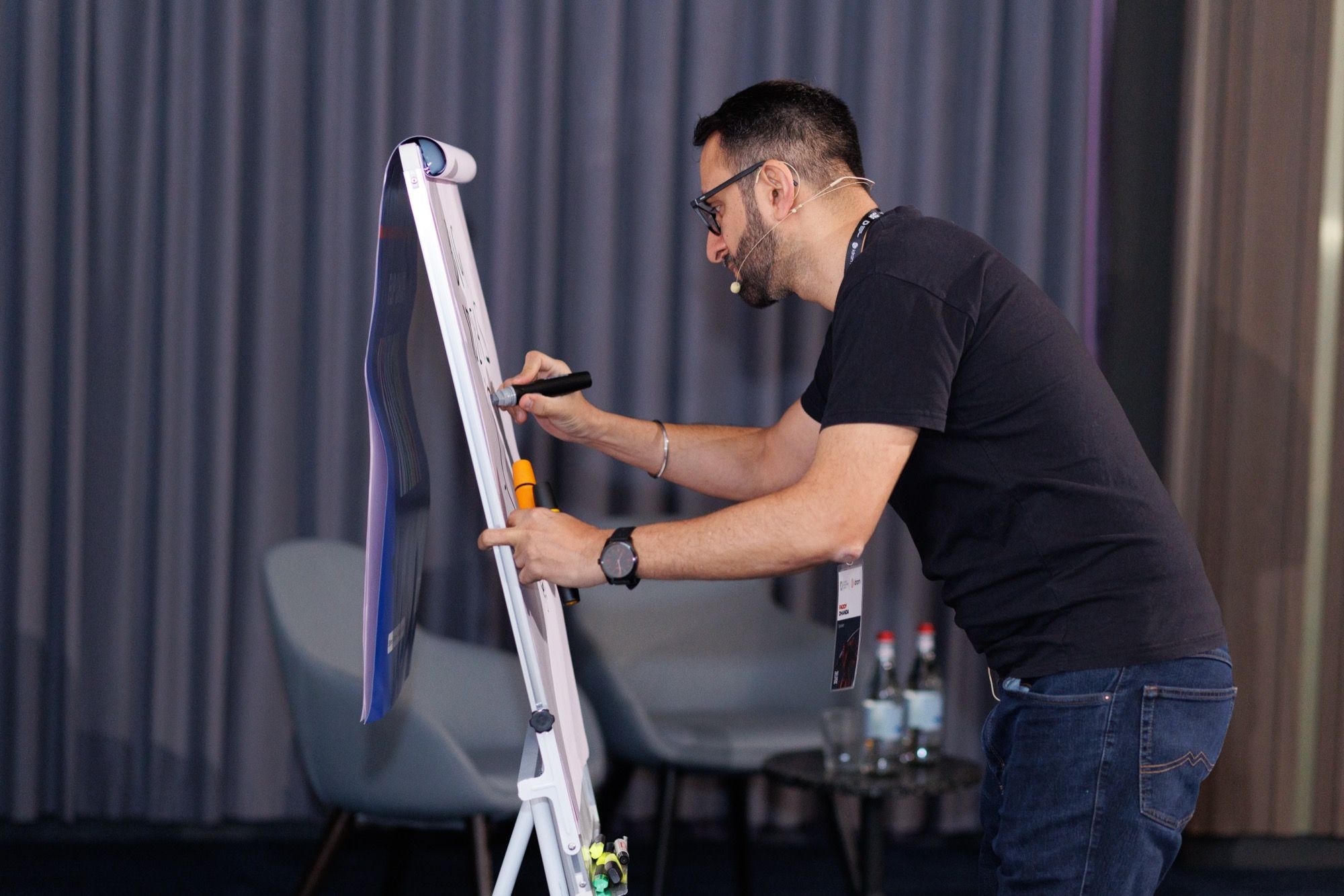 Paddy drawing diagrams on a flip-chart during a workshop